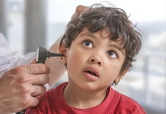 Doctor examining child's ear