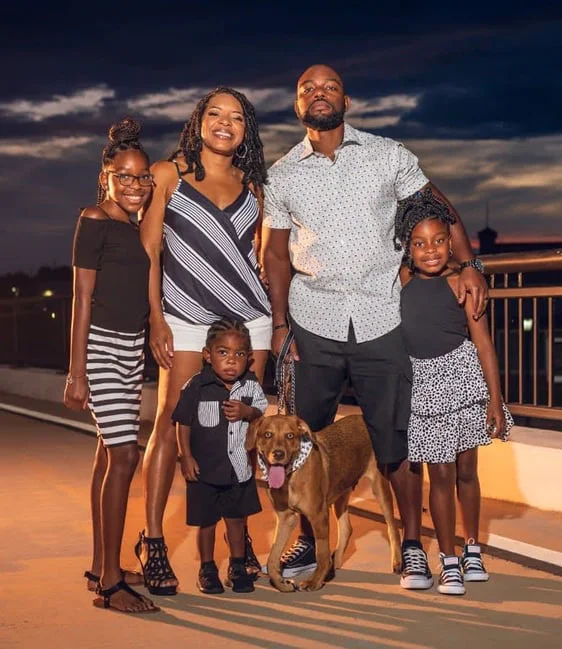 Photo of Nikkita's family with husband, three children, and a dog
