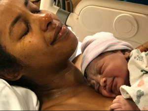 A mother conducting skin-to-skin contact with her newborn