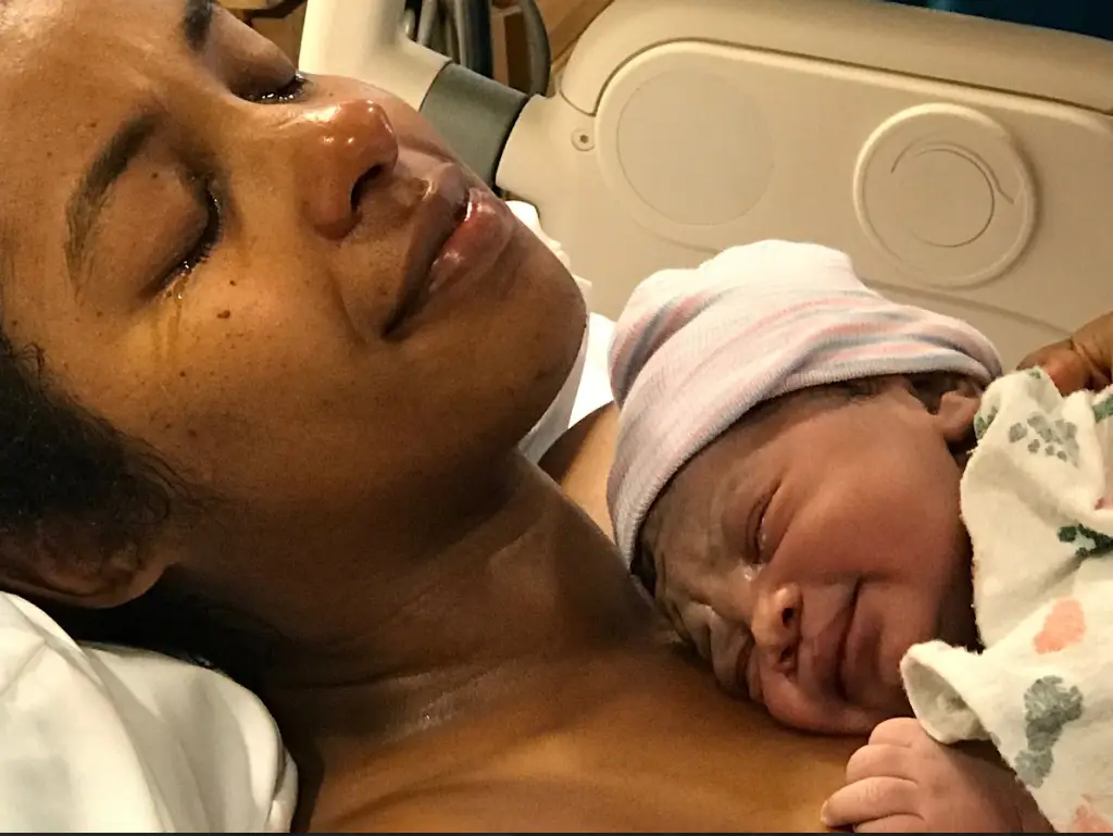 A mother conducting skin-to-skin contact with her newborn