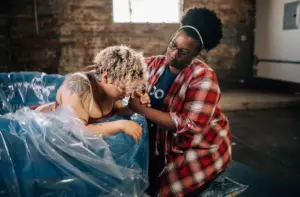 A doula helping a mom in a birth tub