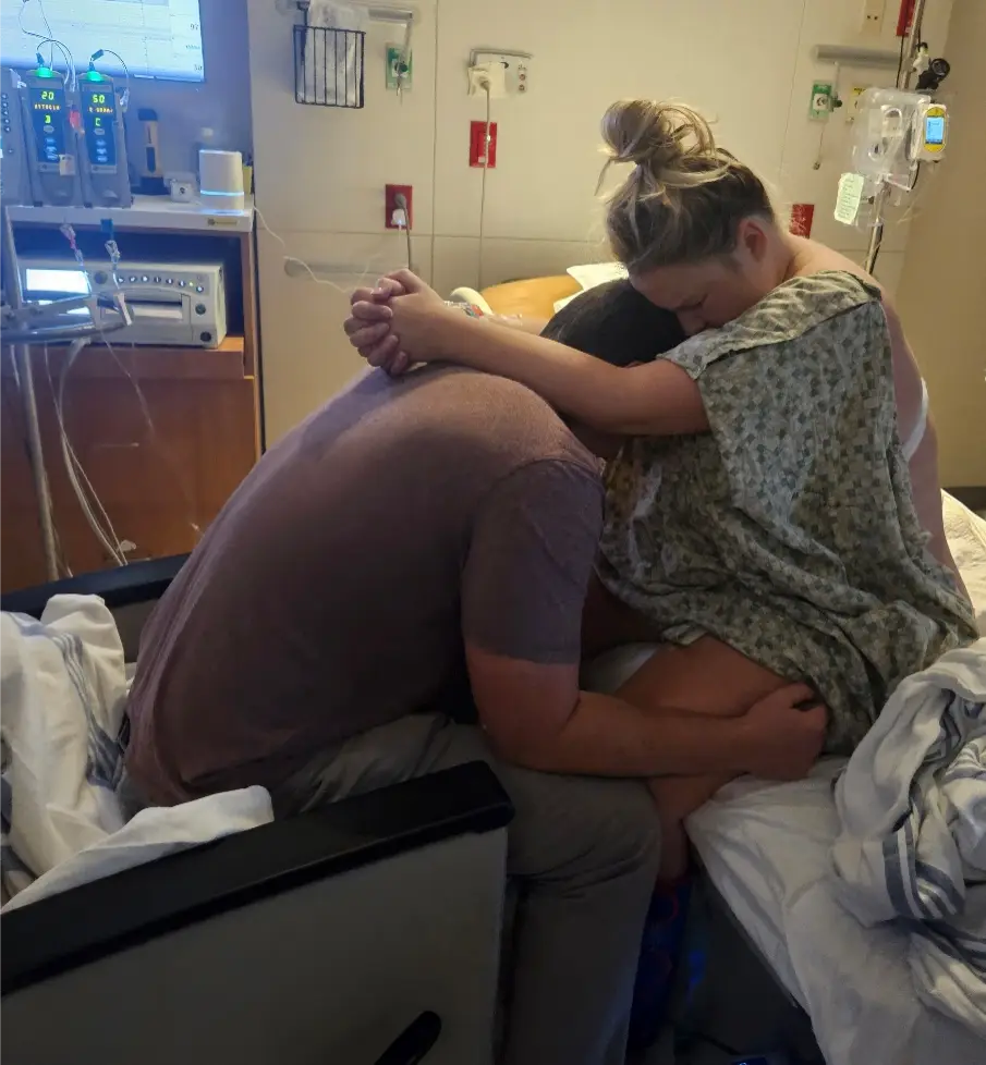 Husband supporting wife in the hospital before birth