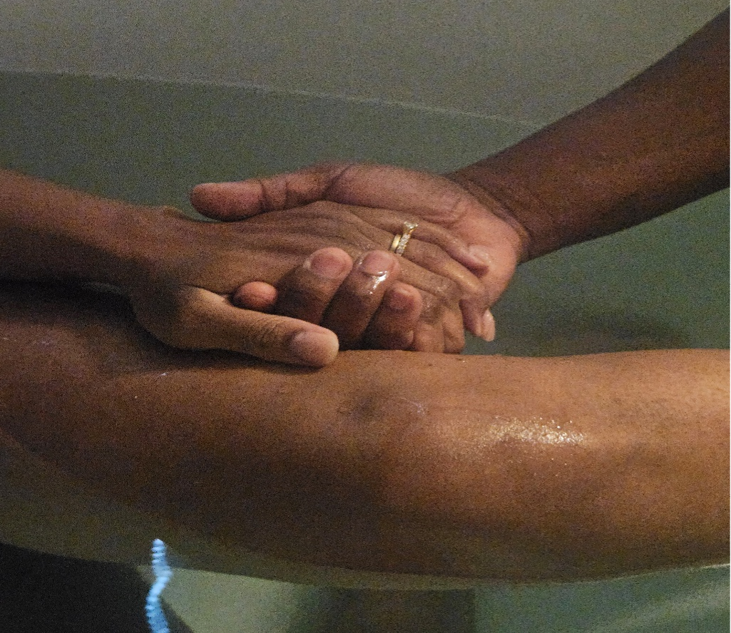 Husband and wife holding hands during labor