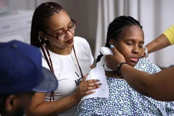 Labor doula supporting a woman during childbirth with partner and care team present
