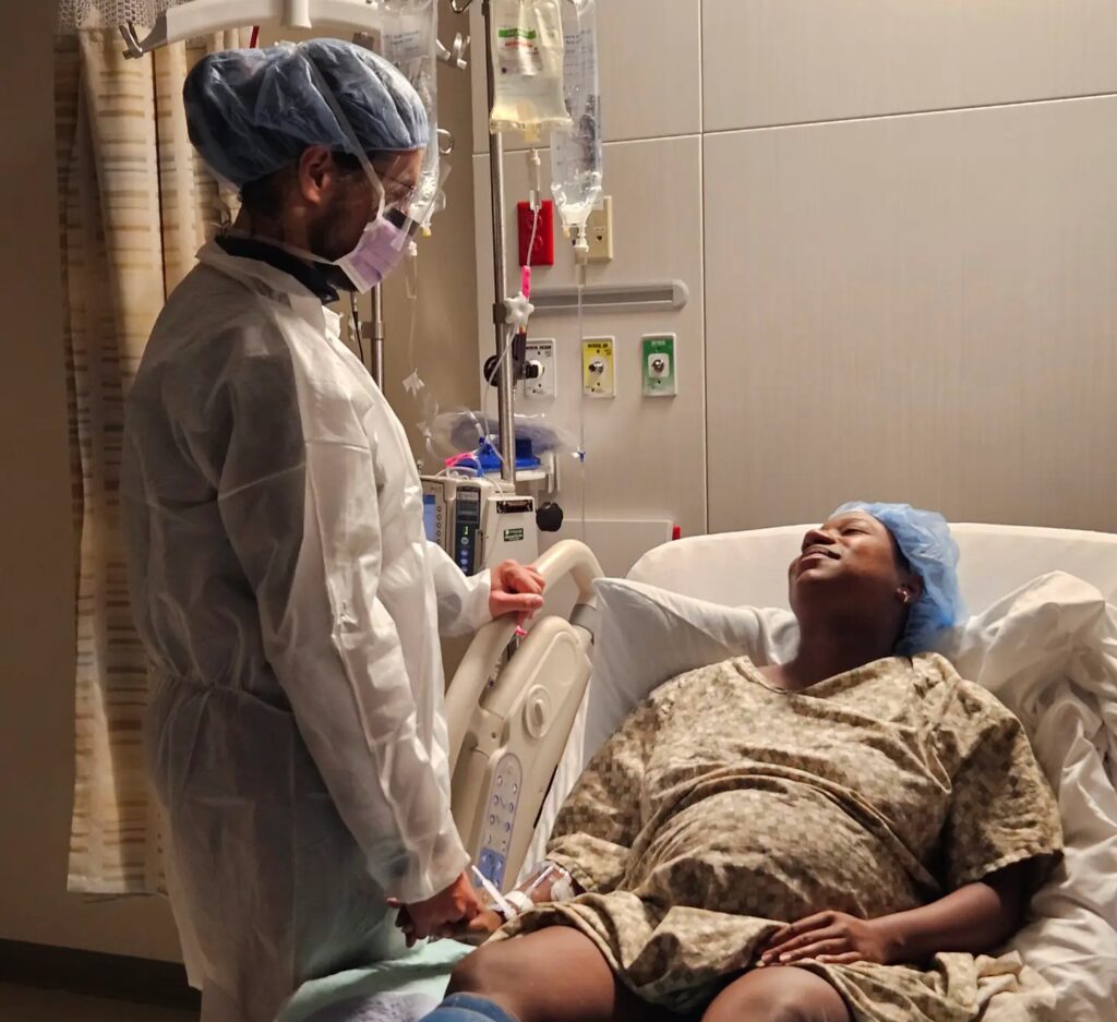 Partner supporting a pregnant mother in the hospital after birth plans changed