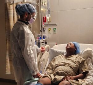 Partner supporting a pregnant mother in the hospital after birth plans changed